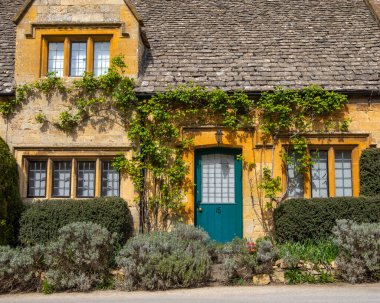 Cotswolds, UK - April 11th 2022: Beautiful facade of a cottage in the Cotswold village of Stanton in Gloucestershire, UK.