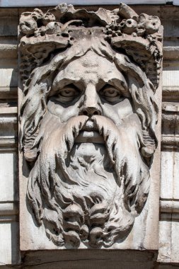 A sculpture of Old Father Thames, on the exterior of Somerset House in London, UK.  Old Father Thames is Londons very own river God named after the River Thames.