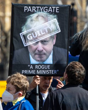 Londra, İngiltere - 20 Nisan 2022: Westminster, Londra 'daki Parlamento Binaları önünde Boris Johnson ve Parti efsanesini protesto eden bir protestocu.