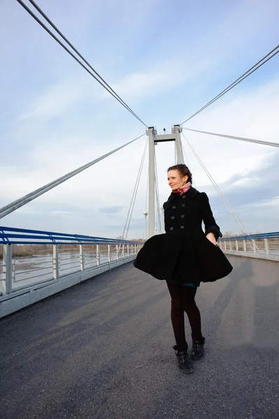 Girl walking alone on the bridge — Stock Photo, Image