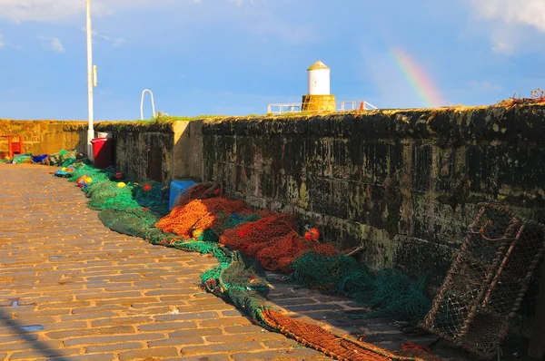 Fishing nets under a rainbow. — Stock Photo, Image