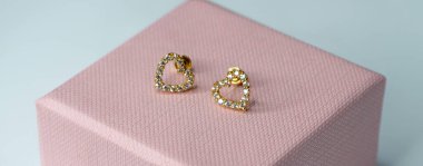 Pembe hediye kutusunda bebekler için kalp şeklinde küpe.