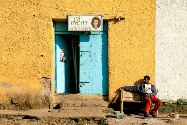 Gonder ethiopia east africa man relaxing outside colourful barbe — Stock Photo, Image