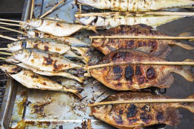 grilled fish in kep market cambodia clipart