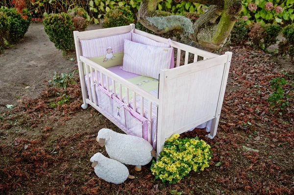 Baby cot bed in garden — Stock Photo, Image