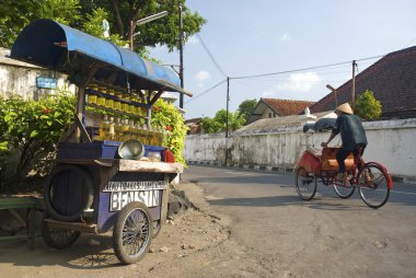 petrol stall and cyclo taxi in solo city indonesia clipart