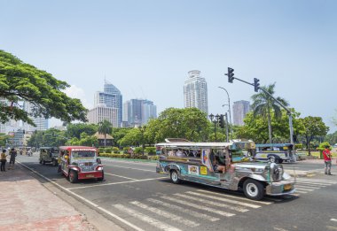 jeepneys in rizal park manila philippines clipart