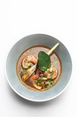 thai tom yam kung spicy curry soup with prawns on white background