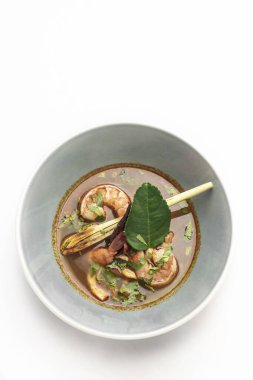 thai tom yam kung spicy curry soup with prawns on white background