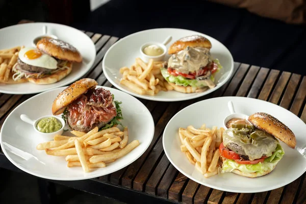 many different burgers on restaurant table