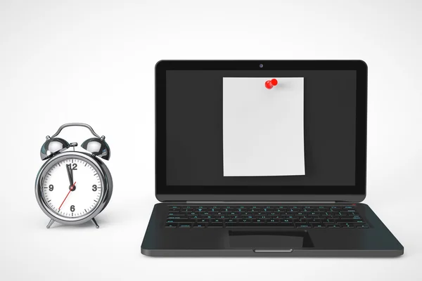 Relógio de alarme com computador portátil e papel de nota em branco — Fotografia de Stock