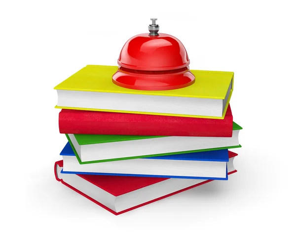 Cloche de service rouge debout sur la pile de livres — Photo