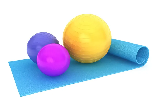 Estera de ejercicio con bolas de fitness coloridas — Foto de Stock