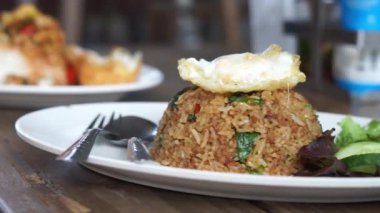 Close up Stir fried Minced pork with basil and fried egg and fish sauce dip background fast food Thai Style food. Thailand street food. Thailand's national dishes, Thai name is Pad kra prao Mou