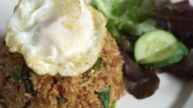 Close up Stir fried Minced pork with basil and fried egg and fish sauce dip background fast food Thai Style food. Thailand street food. Thailand's national dishes, Thai name is Pad kra prao Mou