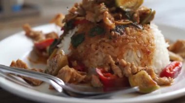 Stir fried pork with red curry paste and basil leaves with yardlong bean and fried egg