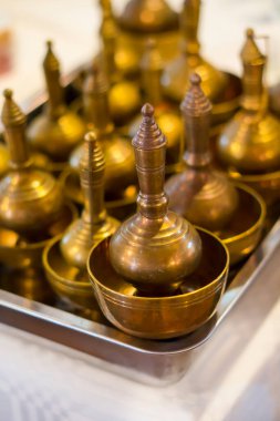 pouring water to the golden bowl, in Thai tradition pouring water is to dedicate to good will to the enemies of the passed away