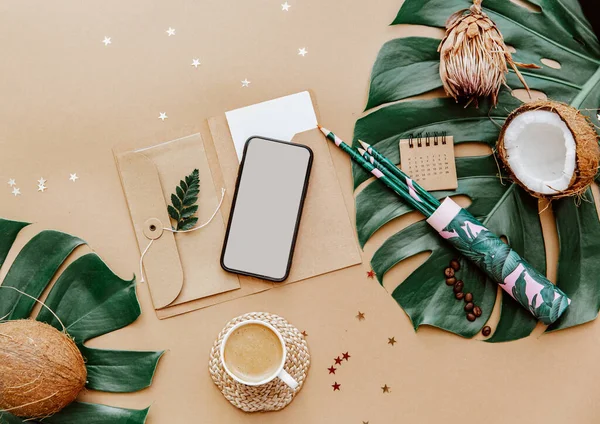 Summer Flat lay workspace with cup of coffee, coconut, monstera leaves and phone. Ideas, notes or plan writing concept. Minimal eco friendly blogger. Zero waste.