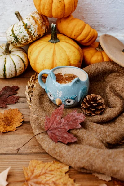 Autumn composition with coffee, autumn leaves, warm sweater and  pumpkins on wooden background, Autumn still life,  Autumn, fall, halloween, thanksgiving day concept.