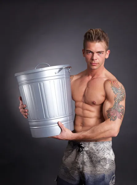 Homem musculoso com lixo — Fotografia de Stock