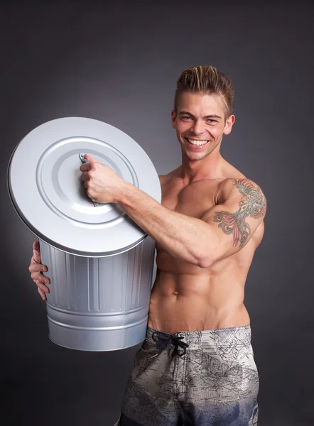 Muscular man with trash — Stock Photo, Image