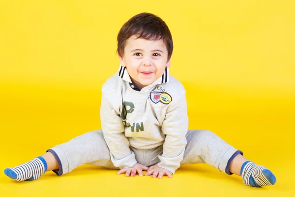 Little boy on yellow background — Stock Photo, Image