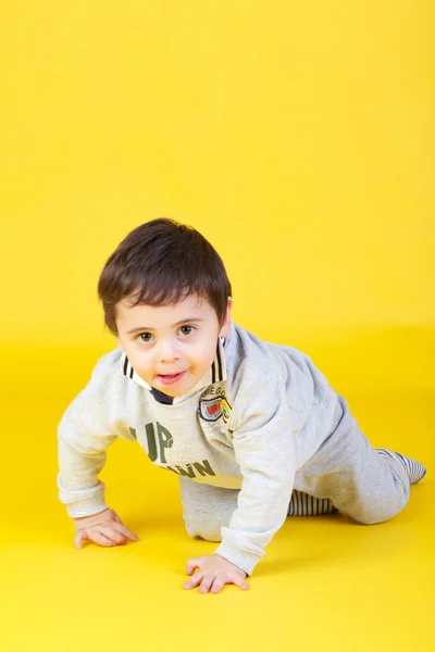 Little boy on yellow background — Stock Photo, Image