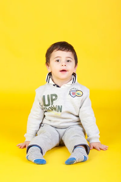 Little boy on yellow background — Stock Photo, Image