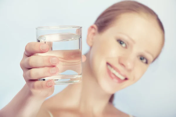 Young healthy woman and a glass of clean water — Stock Photo, Image