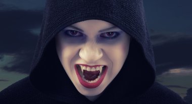Angry woman vampire against the dark sky clipart