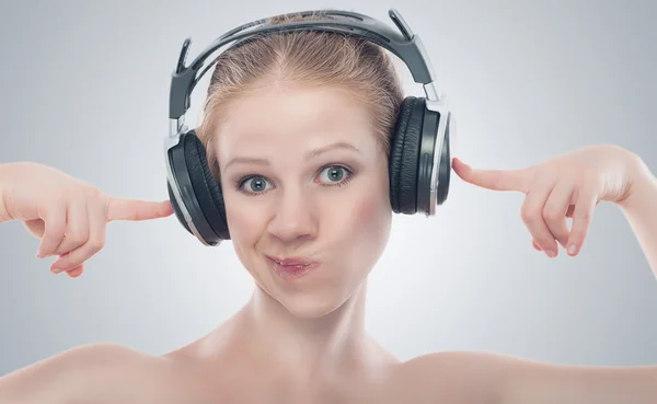 Funny girl listening to music on headphones — Stock Photo, Image