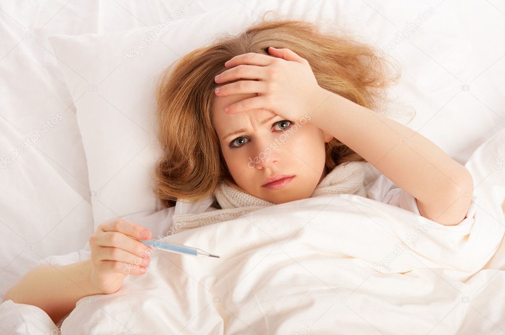 Woman with thermometer sick colds, flu, fever in bed