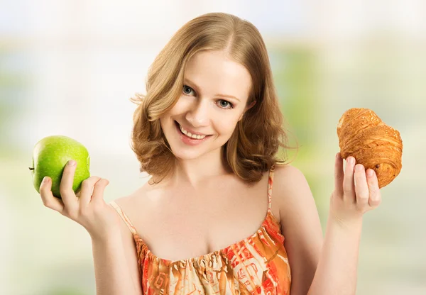 Woman choose between healthy and unhealthy food Stock Image