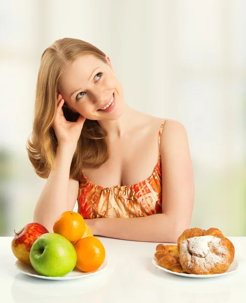 Woman choose between healthy and unhealthy food Stock Picture