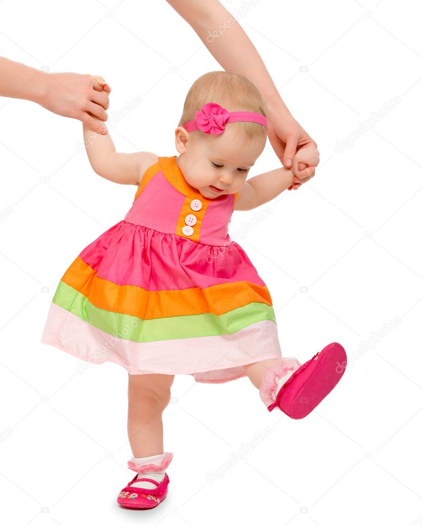 first steps of a beautiful cute baby girl with hand of mother i