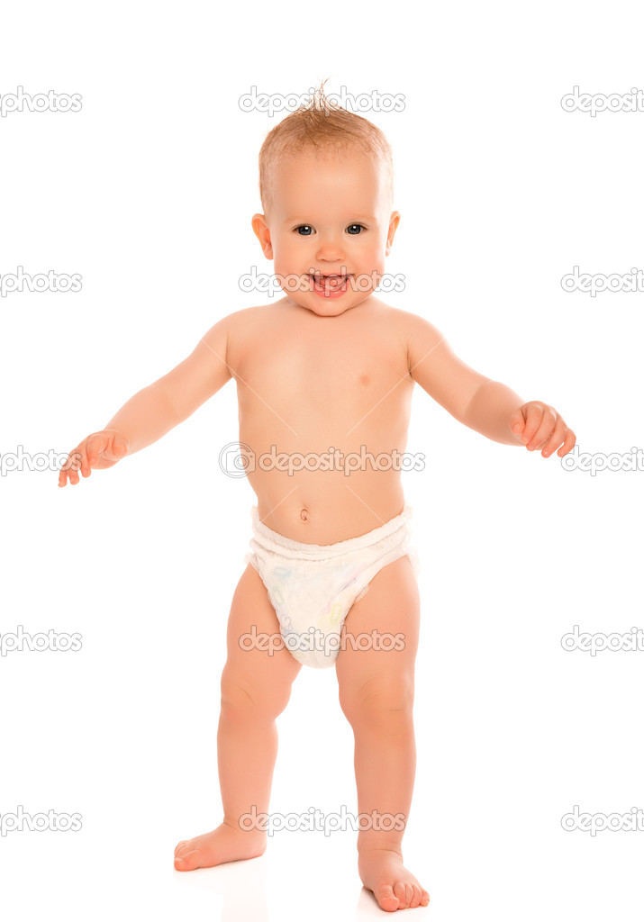 Happy beautiful baby stands in a diaper isolated