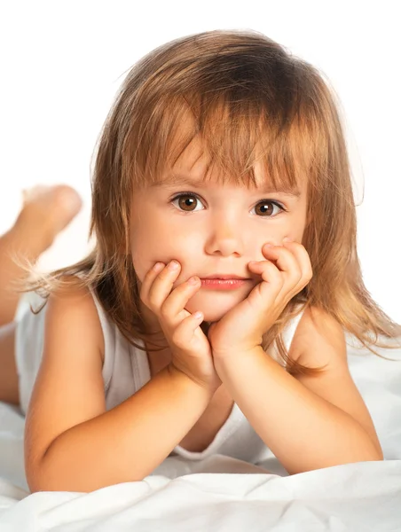 Little happy smiling cheerful girl in a bed isolated Royalty Free Stock Images