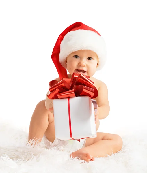 Happy baby in a Christmas hat with a gift isolated — Stock Photo, Image