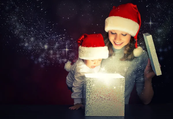 Caja de regalo mágica de Navidad y una feliz madre y bebé de la familia —  Fotos de Stock