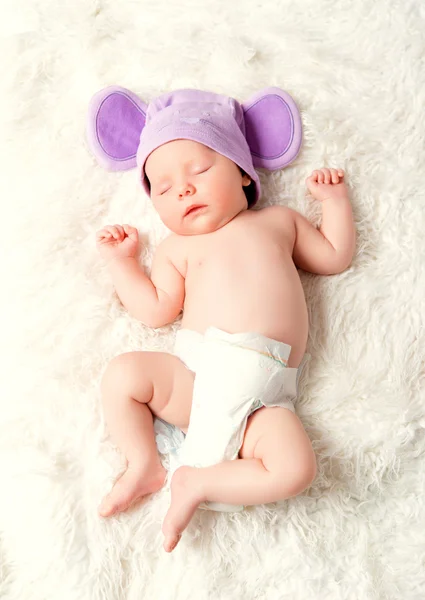 Cute newborn baby sleeps in a hat with ears — Stock Photo, Image