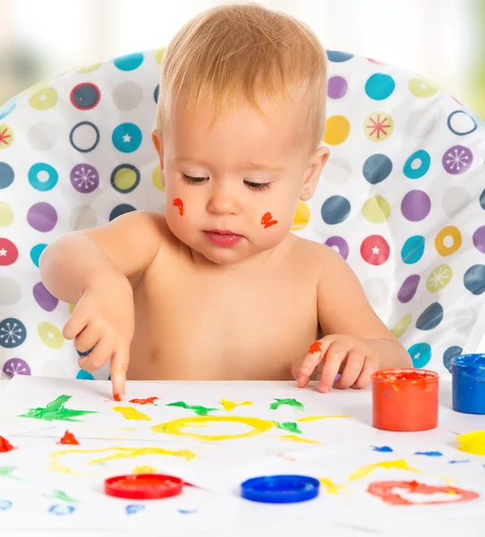 Happy child draws with colored paints hands — Stock Photo, Image