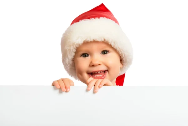 Happy baby in a Christmas hat and a blank billboard isolated on — Stock Photo, Image