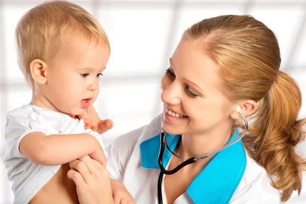 Baby and doctor pediatrician. doctor listens to the heart with s Stock Photo