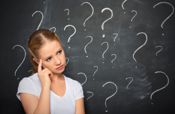 concept of woman and question mark drawn in chalk on blackboard