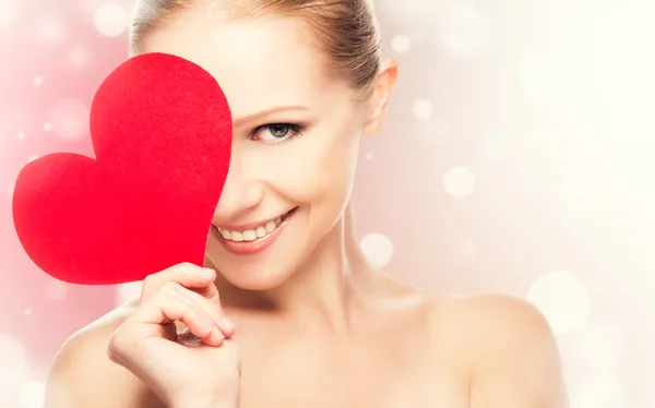 Face of a beautiful young woman with red heart — Stock Photo, Image