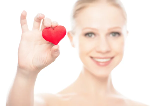 Face of a beautiful young woman with red heart — Stock Photo, Image