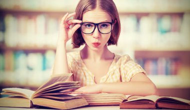 funny girl student with glasses reading books clipart