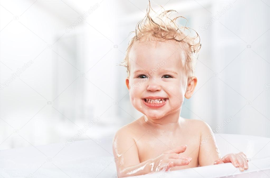 Happy funny baby laughing and bathed in bath Stock Photo by