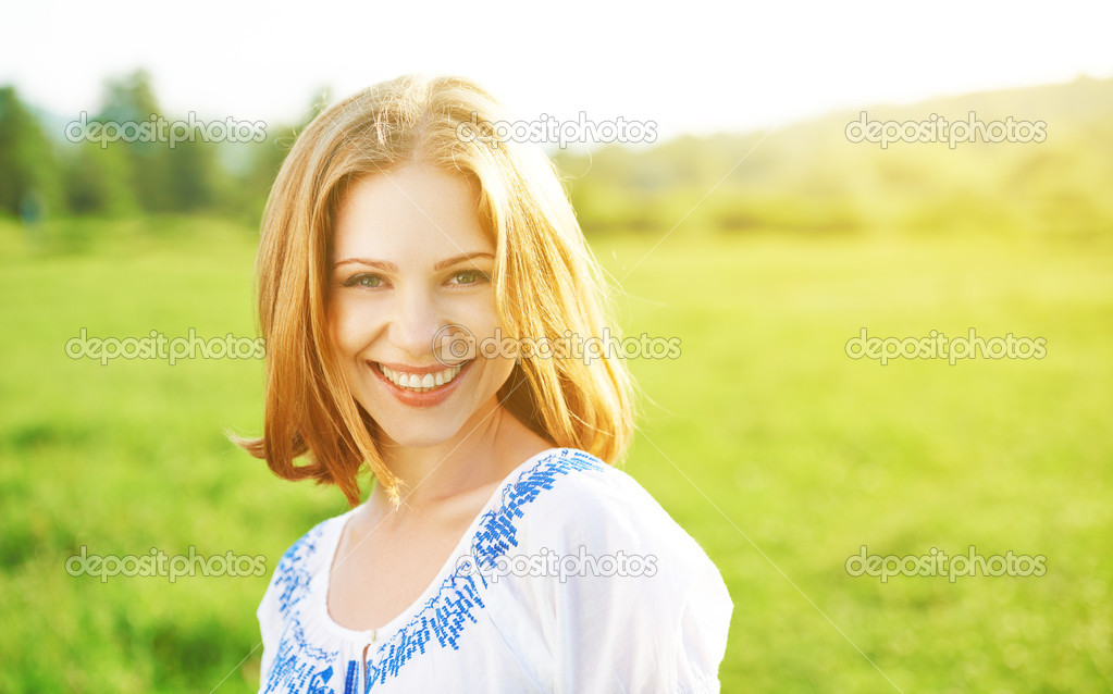 happy beautiful young woman laughing and smiling on nature