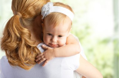 mother hugging and comforting her baby daughter clipart